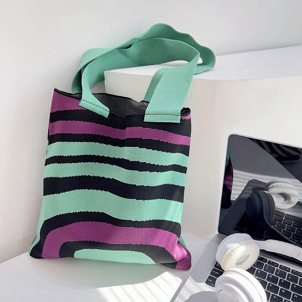 Close-up of Arc Line Knitted Bag in green and purple, ideal for errands and gifting.