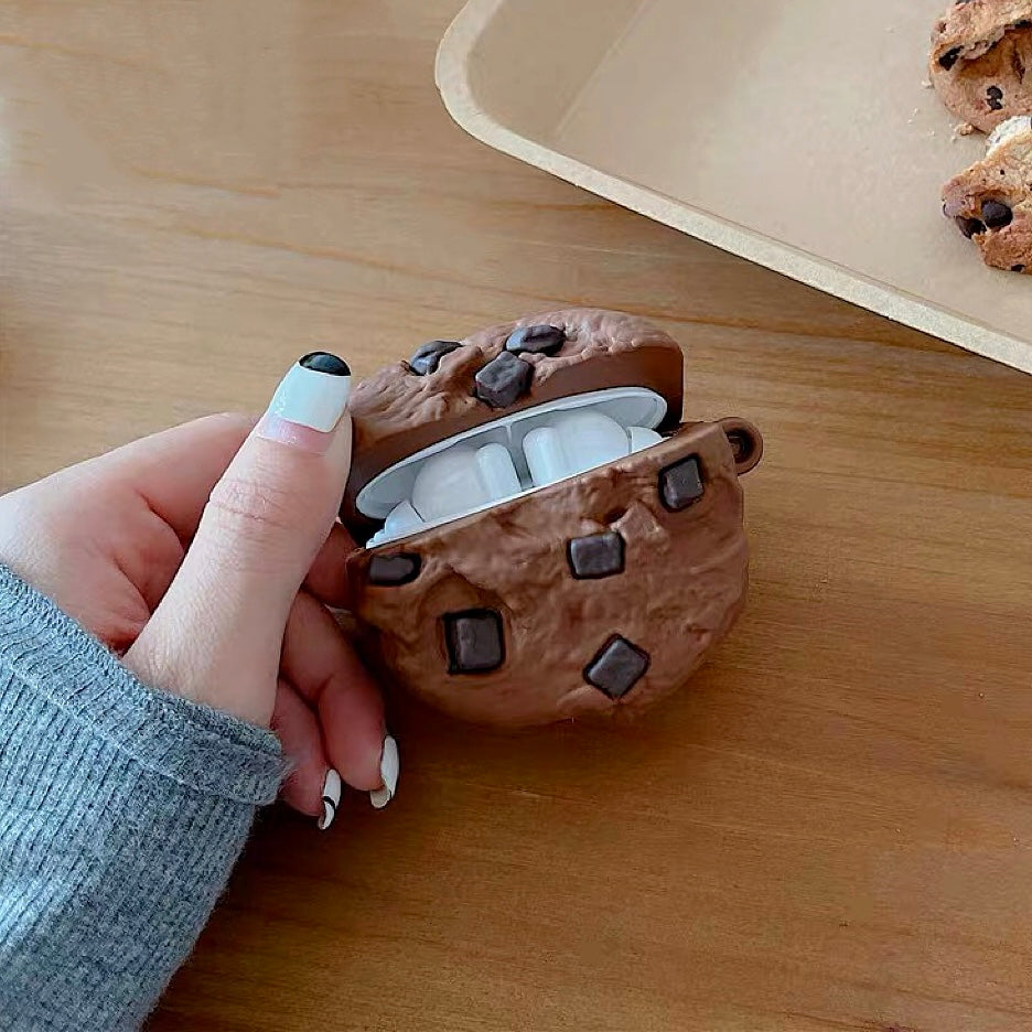 Model Hands holding a brown Chocolate Cookies AirPods case cover, easy to carry for commutes and travel.