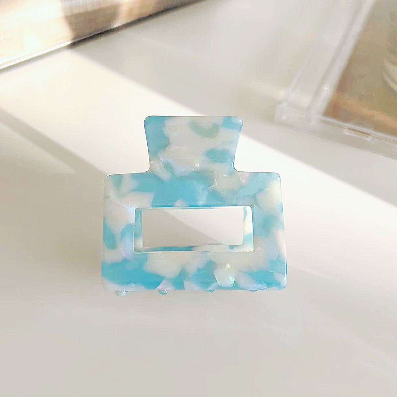 Flat lay of Color Square Hair Claw in blue, easy for workdays and special occasions.