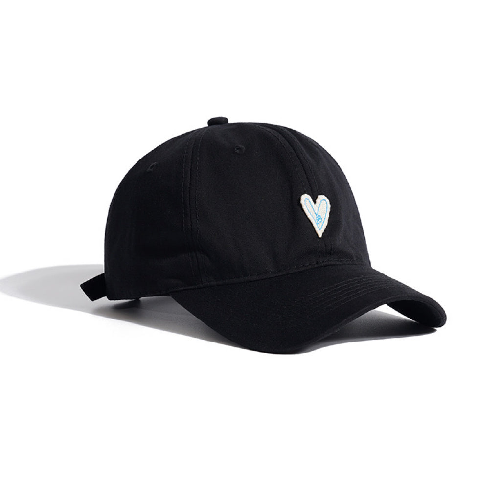 Classic black baseball cap featuring a delicate white heart embroidery detail.