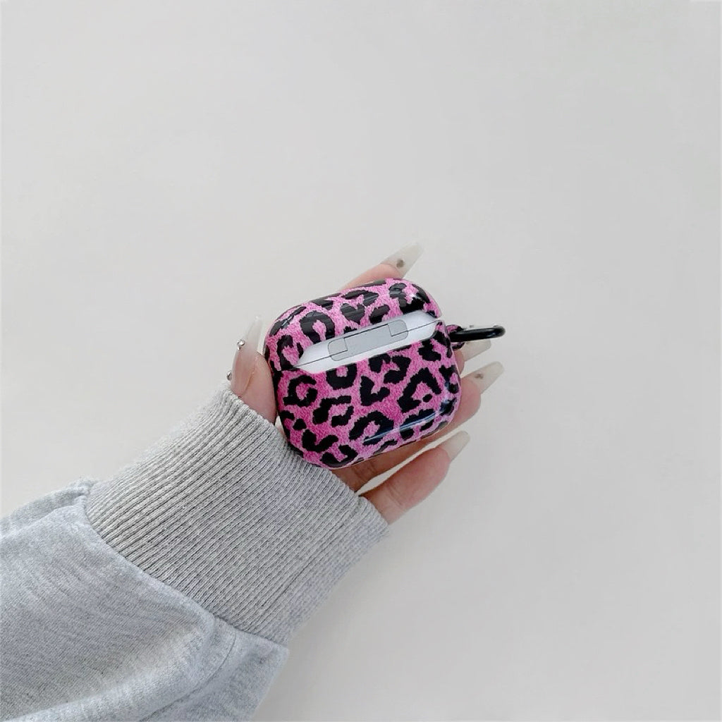 Model Hands holding a pink leopard print airpods case, ideal for gifting and everyday carry.