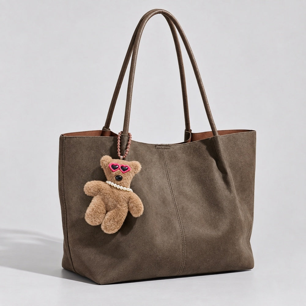 Sunglasses Bear Bag Charm hanging on a suede bag