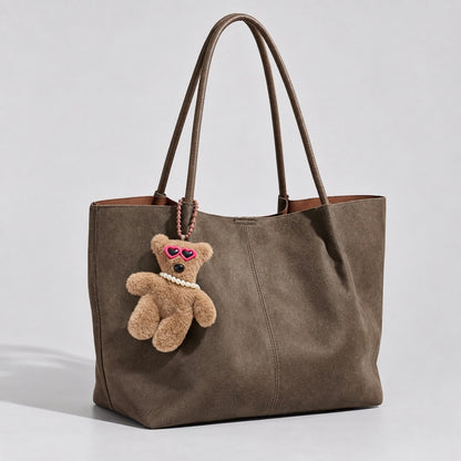 Sunglasses Bear Bag Charm hanging on a suede bag