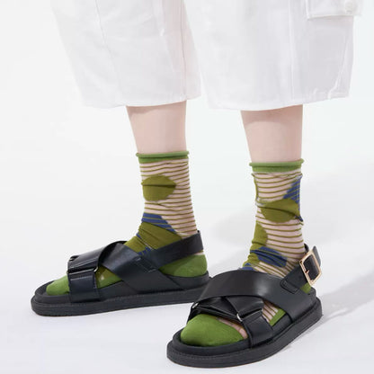 Model wearing a pair of Abstract Pattern Crystal Socks with green bubbles, ideal for workouts and commuting.
