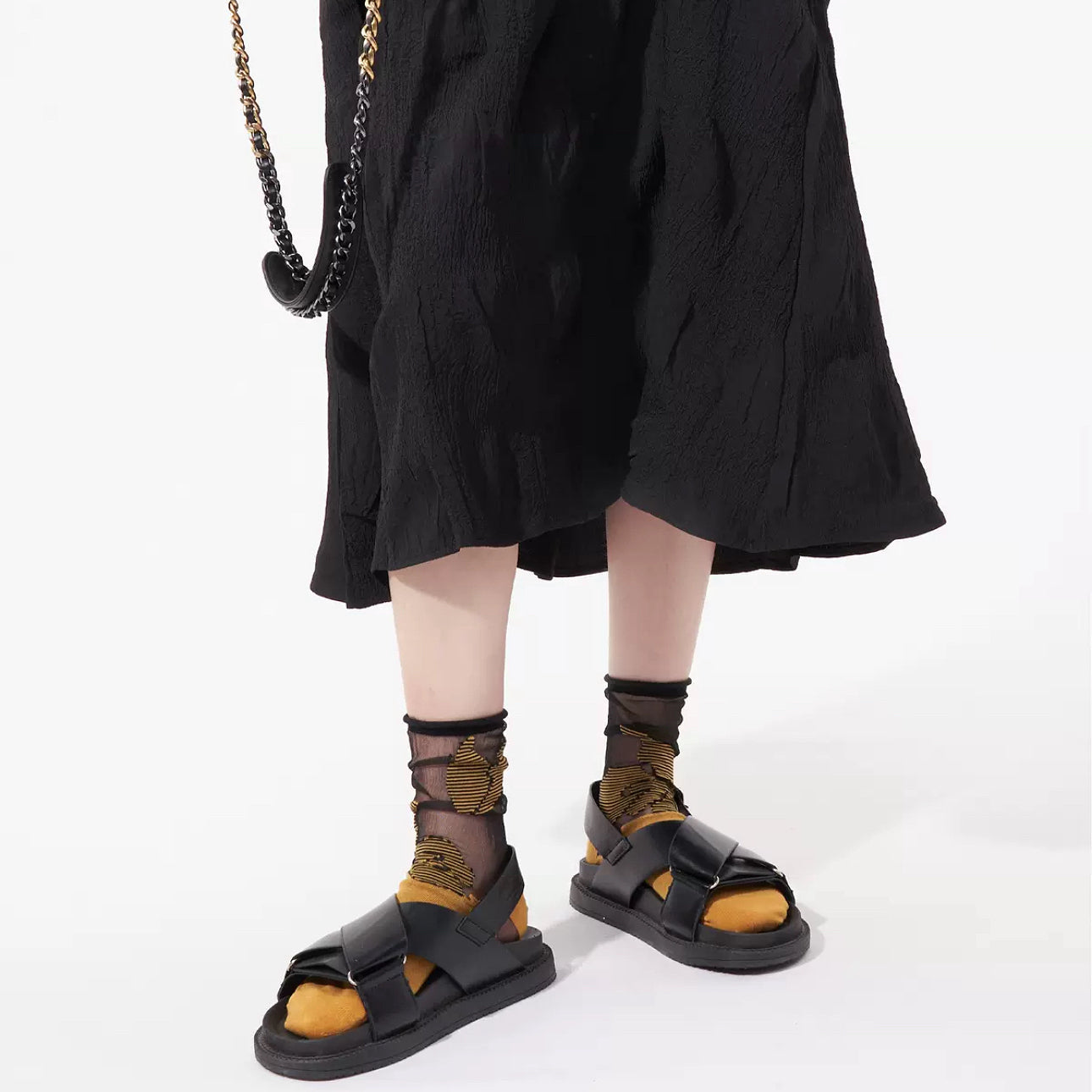 Model wearing a pair of Abstract Pattern Crystal Socks in gold , ideal for everyday outfits and sneakers.