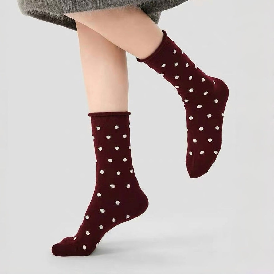 Model wearing a pair of Ancora red polka dot socks , great for casual wear and light workouts.