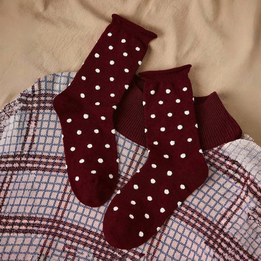 Front view of Ancora red polka dot cotton-polyester socks with white dots.