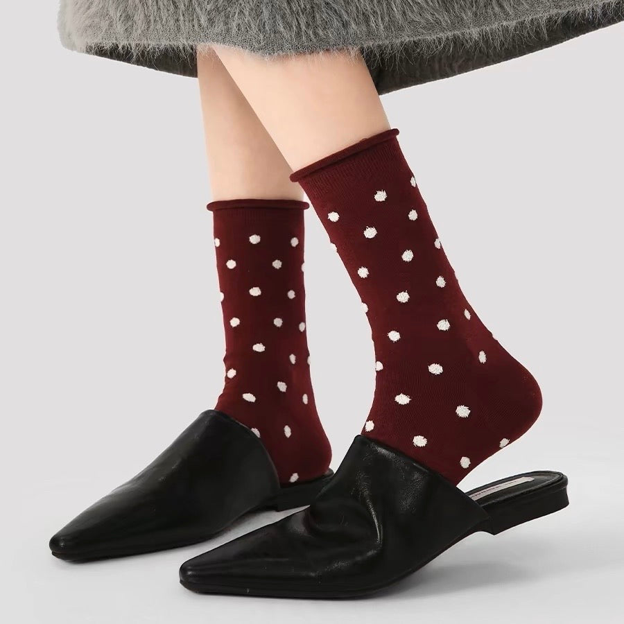 Model wearing a pair of Ancora Red Polka Dot Socks, easy to pack for travel and errands.