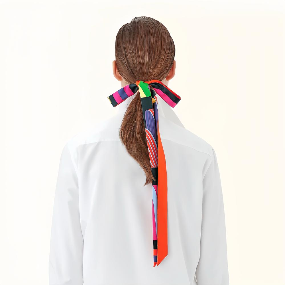 Model wearing a geometric polyester scarf in orange, easy for weekend styling and gifting.