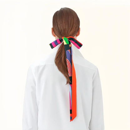 Model wearing a geometric polyester scarf in orange, easy for weekend styling and gifting.
