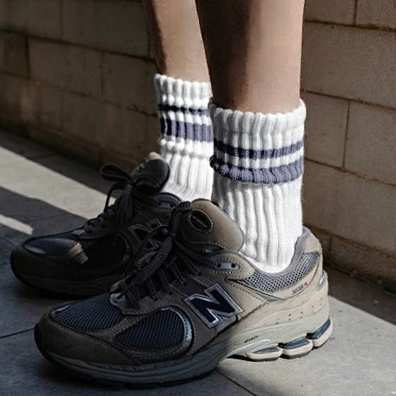 Model wearing a pair of gray striped cotton socks, easy for travel days and daily comfort.