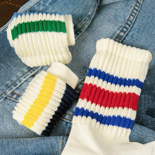 Three pairs of White Blockcore Slouch Socks with colorful stripes on ribbed cotton-polyester fabric.