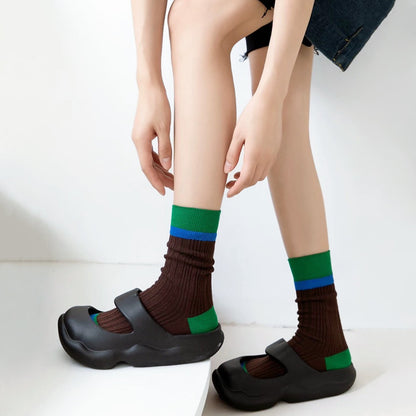 Model wearing a pair of Bold Clash Socks in brown, great for daily wear and lounging.