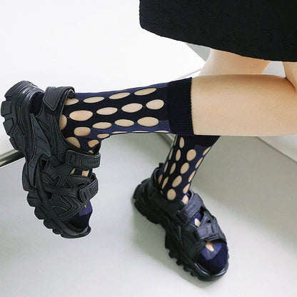 Model wearing a pair of  Bold Hollow Socks in dark blue, great for daily wear and lounging.