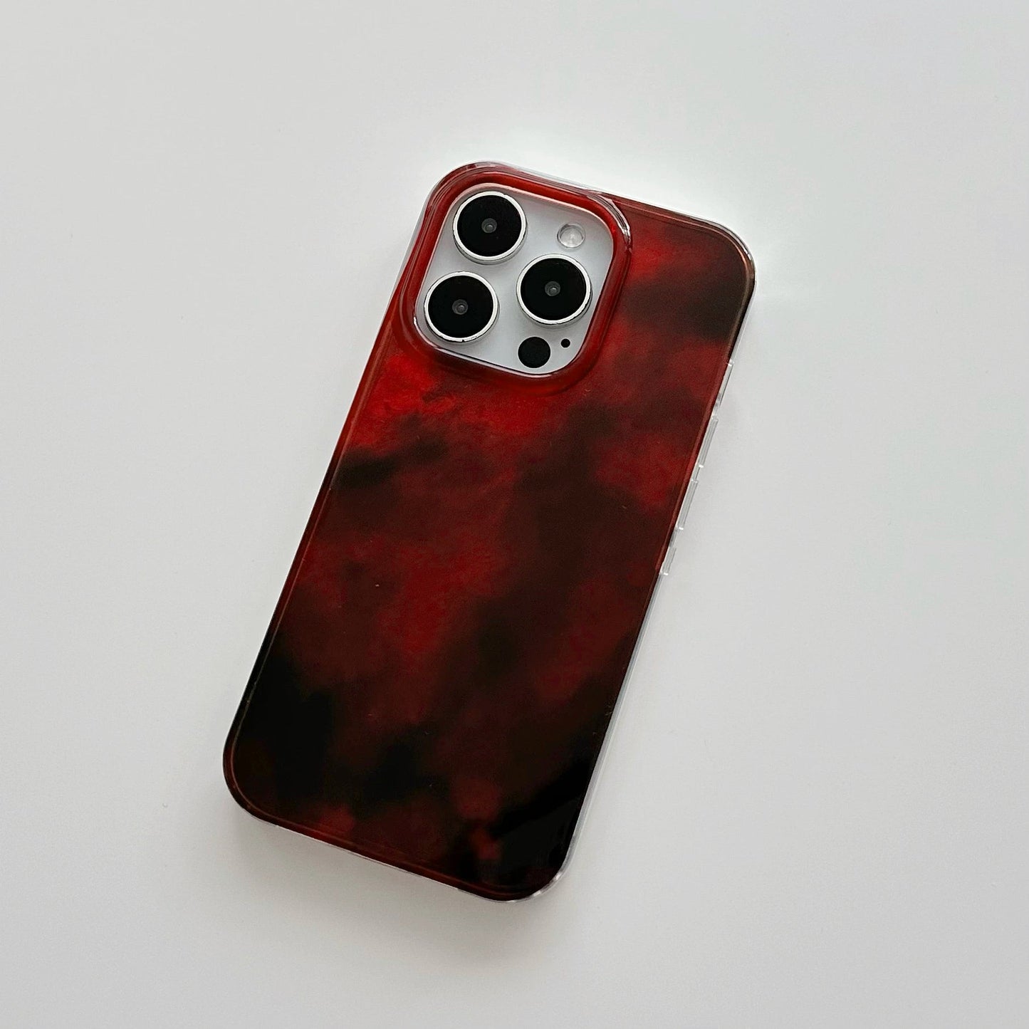 Front view of Burgundy Flux Case. High-gloss gradient effect on durable acrylic for a modern luxury look.