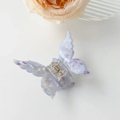 Folded view of butterfly hair claw in purple, ideal for quick updos and ponytails.