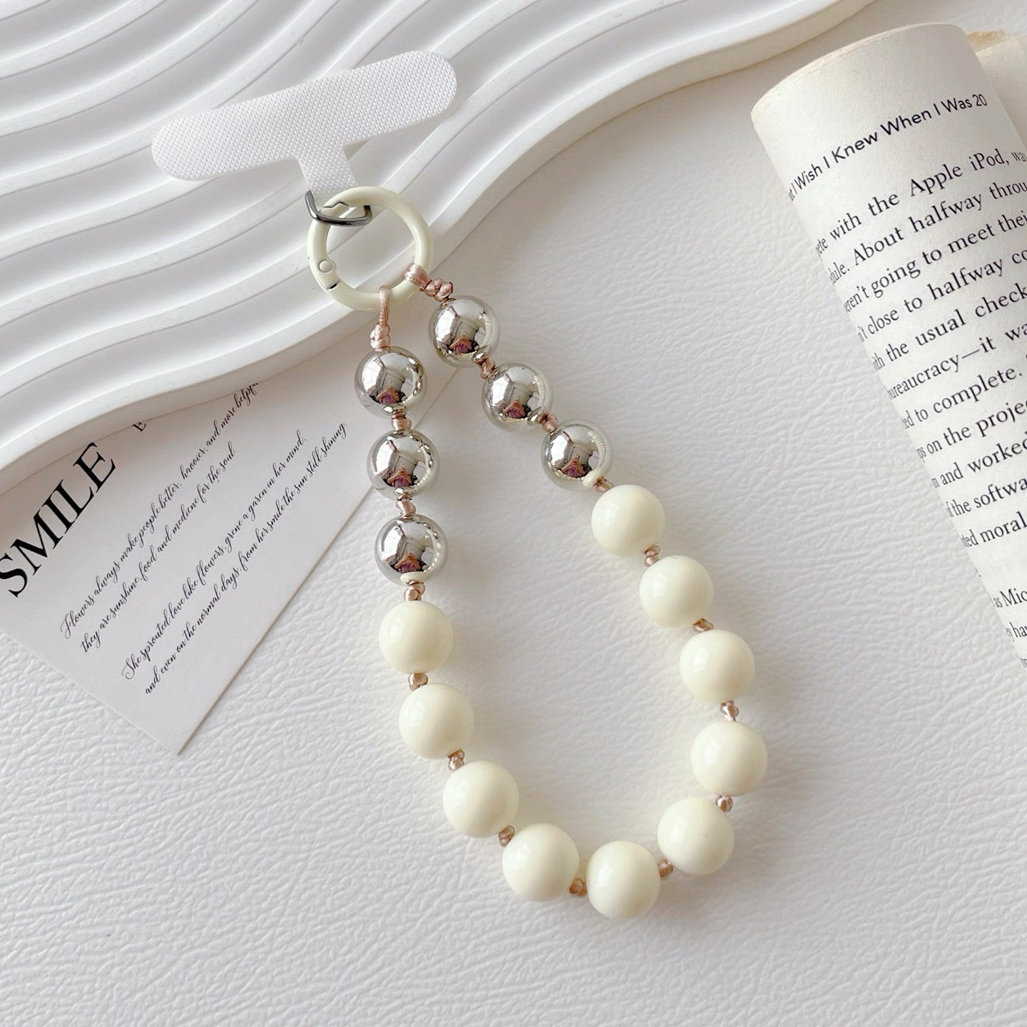 Close-up of Candy Bead Phone Charm in white, easy to attach to bags and phones.