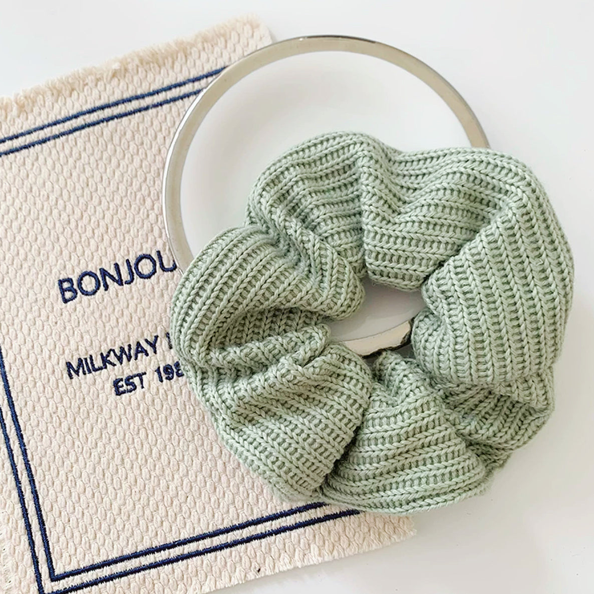Angled view of Candy Knitted Scrunchie in mint green, great for everyday styling and gifting.