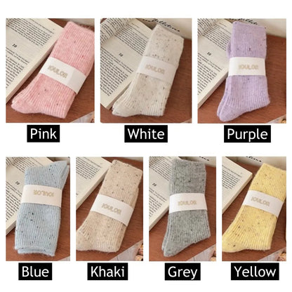 Collection of seven candy-colored thick wool socks displayed flat, including pink, white, purple, blue, khaki, grey and yellow.