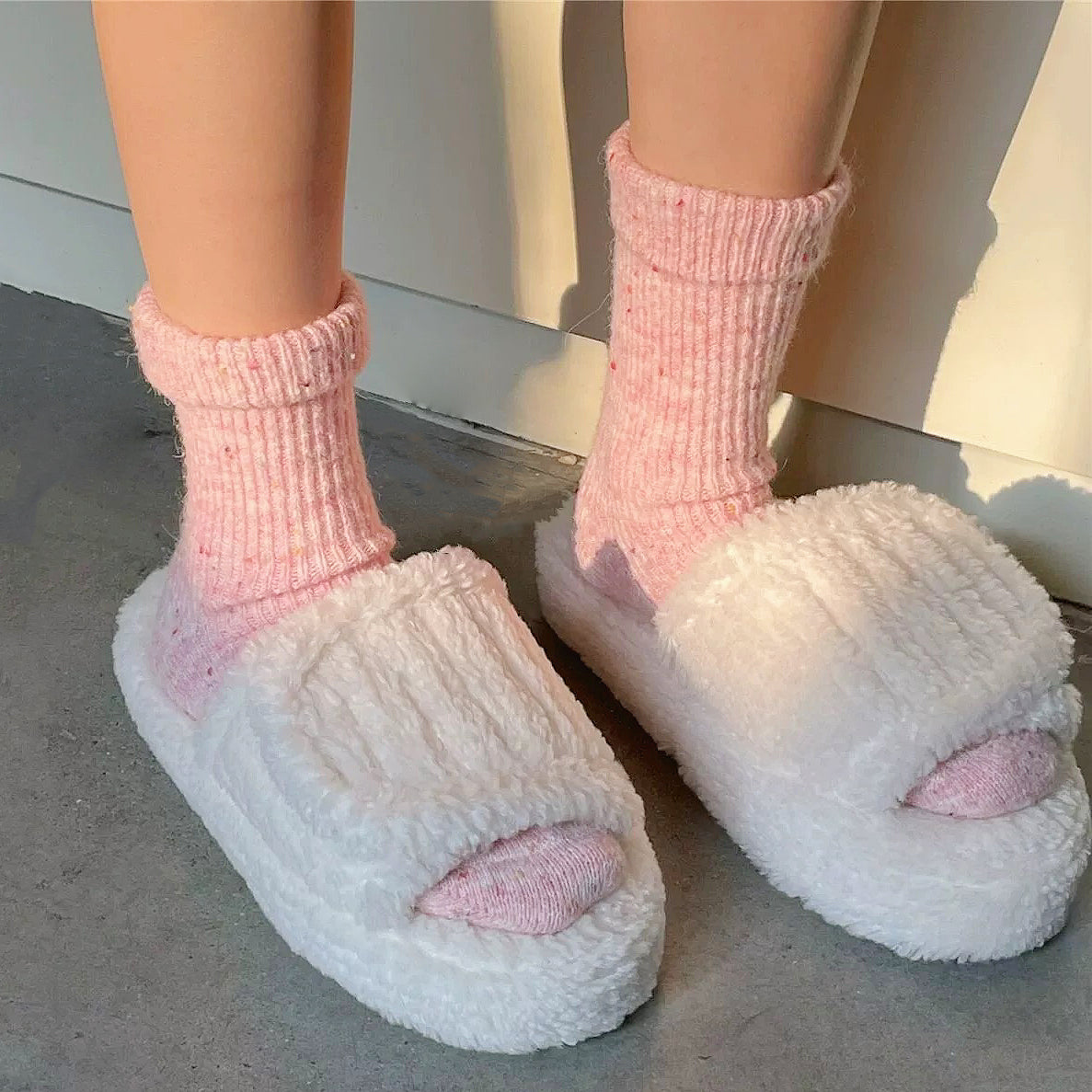 Model wearing the candy-colored pink wool socks for home lounging.