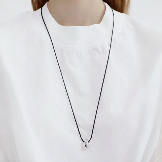 Model wearing silver Celestial Drop Pendant Necklace in Silver, minimalist elegant jewelry style.
