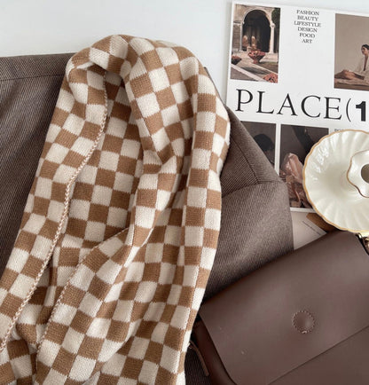 Close-up of a plaid scarf in beige and khaki over a brown blazer, easy for weekend styling and gifting.