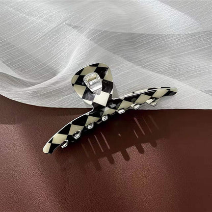 Close-up of checkerboard hair claw in line shape , ideal for quick updos and ponytails.
