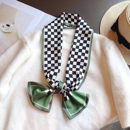Model wearing a plaid satin scarf in green, easy for weekend styling and gifting.