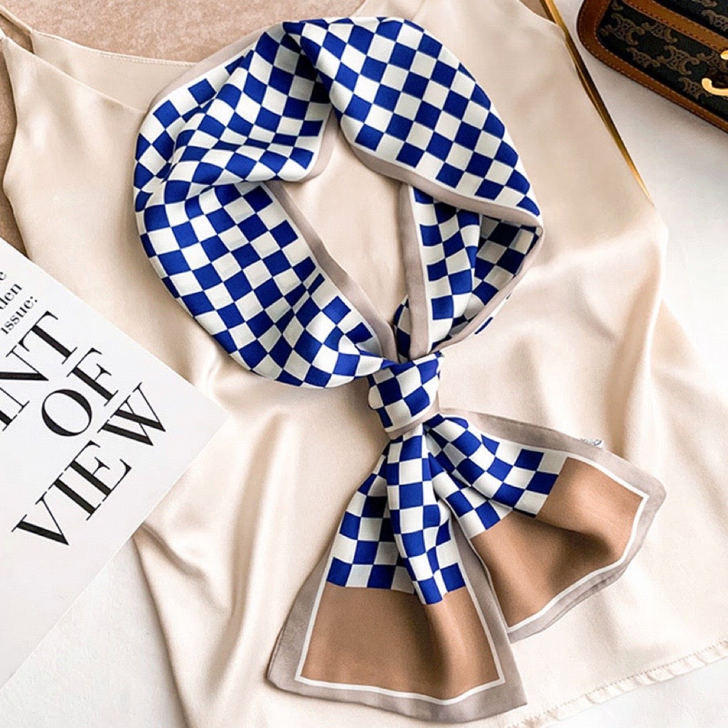 Model wearing a plaid satin scarf in navy and brown and blue, ideal for daily wear and travel.