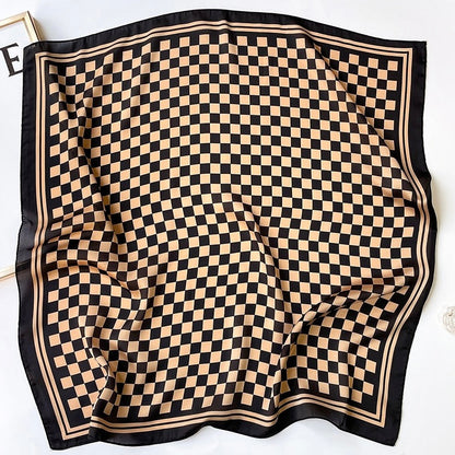 The caramel and black checkerboard scarf spread out flat.