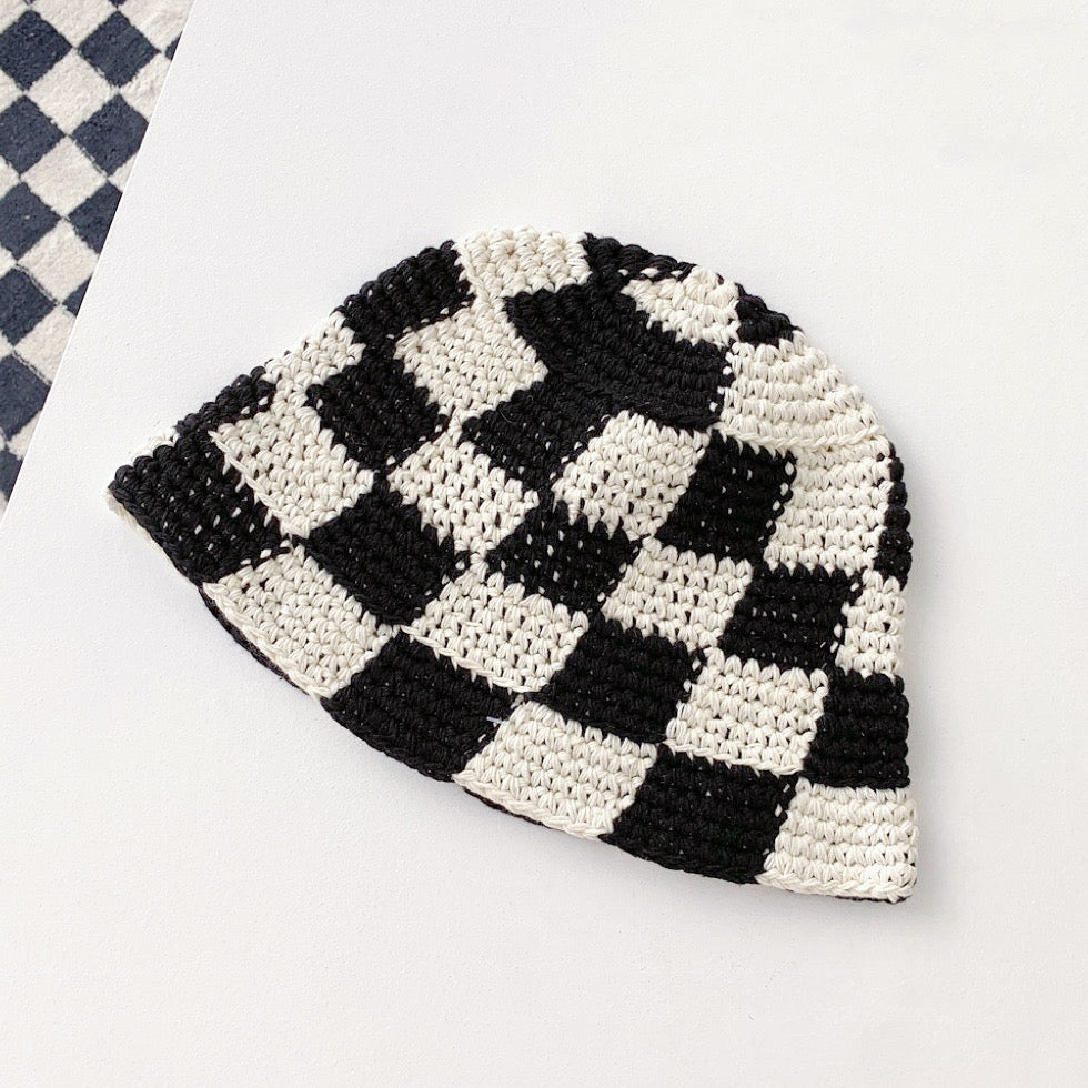 Front view of black checkered crochet bucket hat, featuring a stylish and artisanal handmade look.