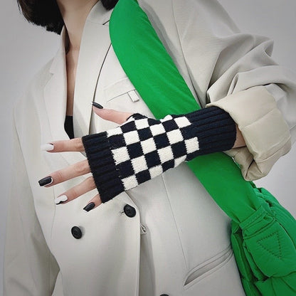 Black checkered gloves with white blazer; chic office-friendly gear for typing in cold workspaces.