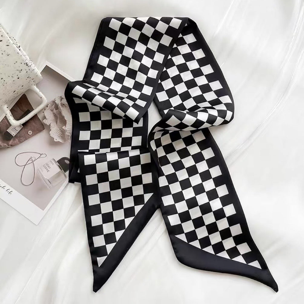 Flat lay of Checkered Silk Like Skinny Scarf in black, great for office layering and commuting.