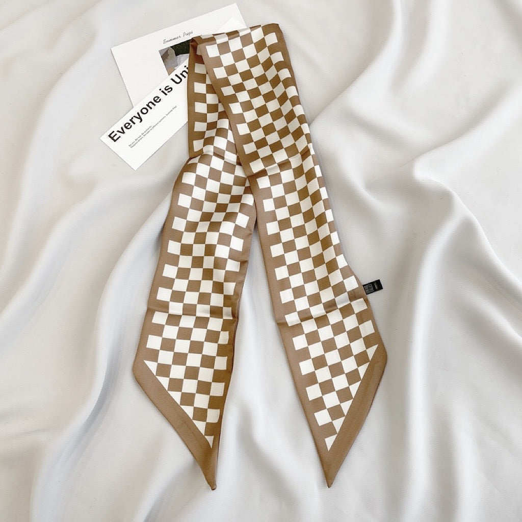 Model wearing a plaid silk scarf Checkered Silk Like Skinny Scarf, easy for weekend styling and gifting.
