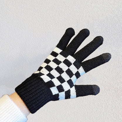 Flat lay checkerboard knitted touch screen gloves, black and cream squares; cozy for winter phone use.