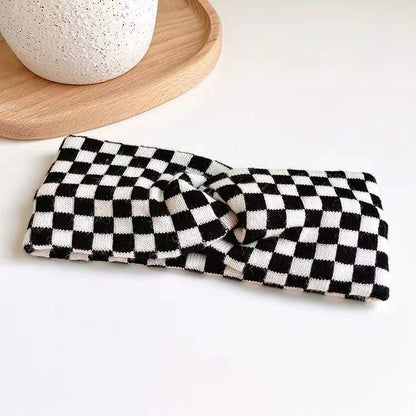 Flat lay of Checkered Twist Headband in black, great for everyday styling and gifting.