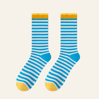 Flat lay of Chromatic Stripe Socks in blue, easy to pack for travel and errands.