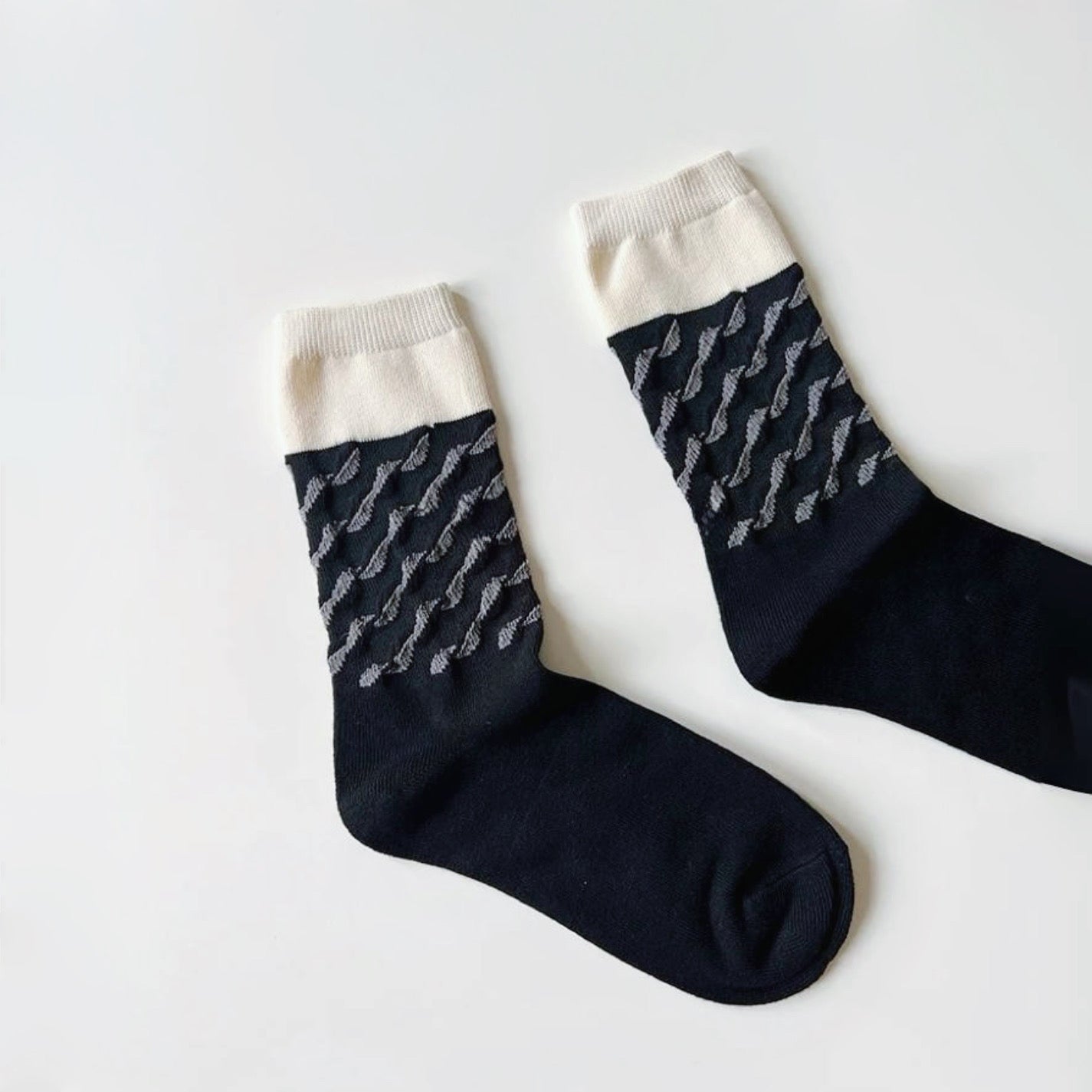 Flat lay of Classical Wave Rhythm Socks in black, great for daily wear and lounging.