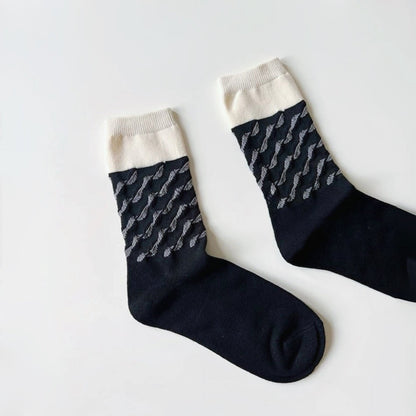 Flat lay of Classical Wave Rhythm Socks in black, great for daily wear and lounging.