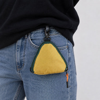 Close-up of a triangle multi-use bag clipped to a belt loop, showing hands-free storage for keys and cards.