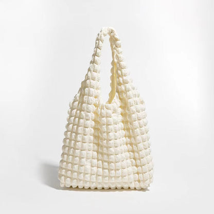 Front view of the cream-colored bubble textured tote bag.