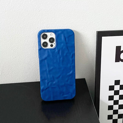 Blue silicone pleated iPhone case. Sleek 3D ripple design with precise camera cutout for minimalist fashion.