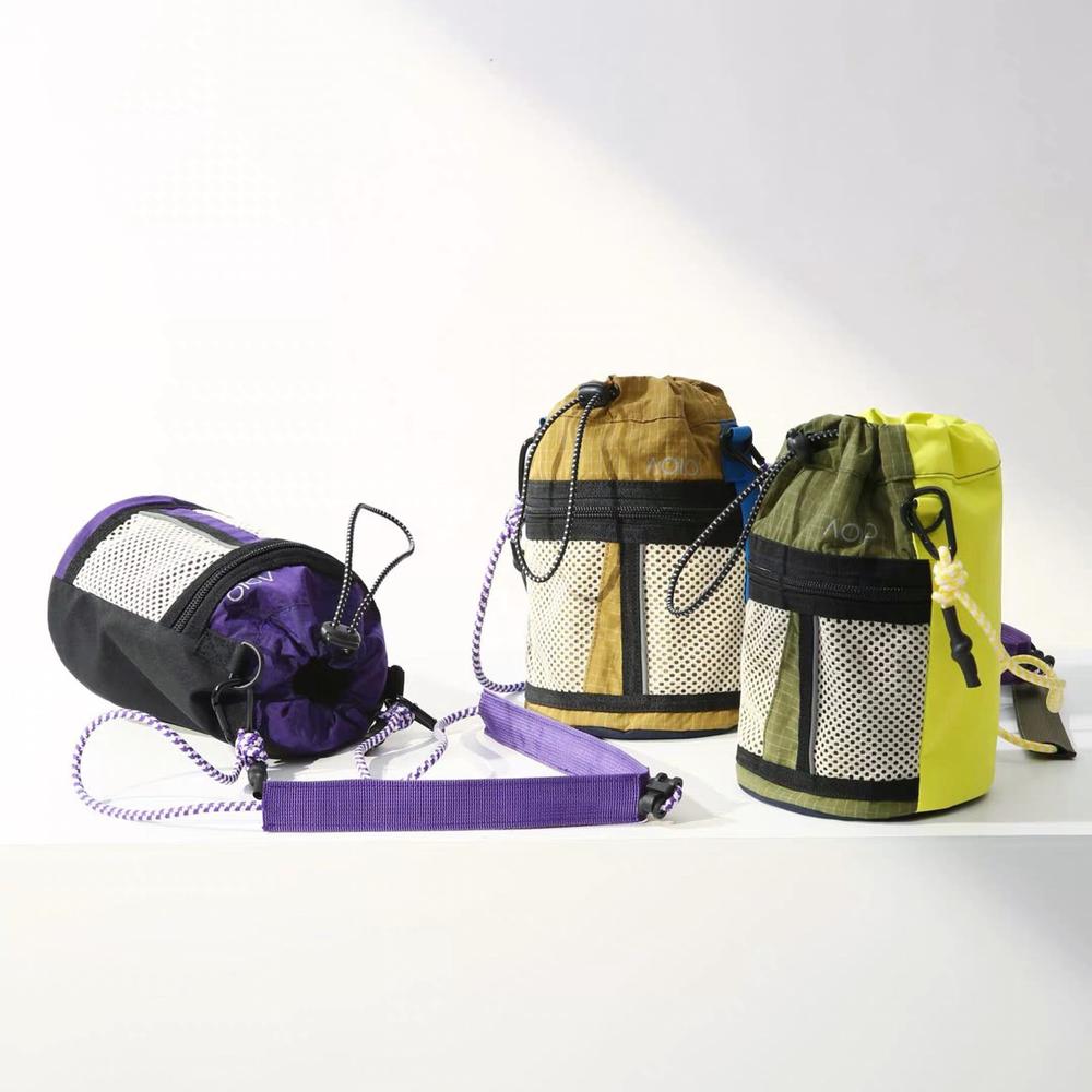 Group of colorblock nylon bucket bags in purple, dark khaki, and olive green.
