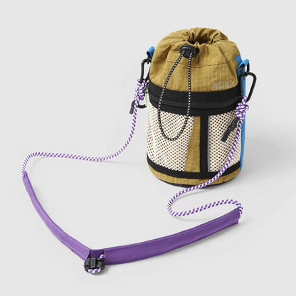 Front view of dark khaki nylon bucket bag with purple strap, ideal for weekend adventures.