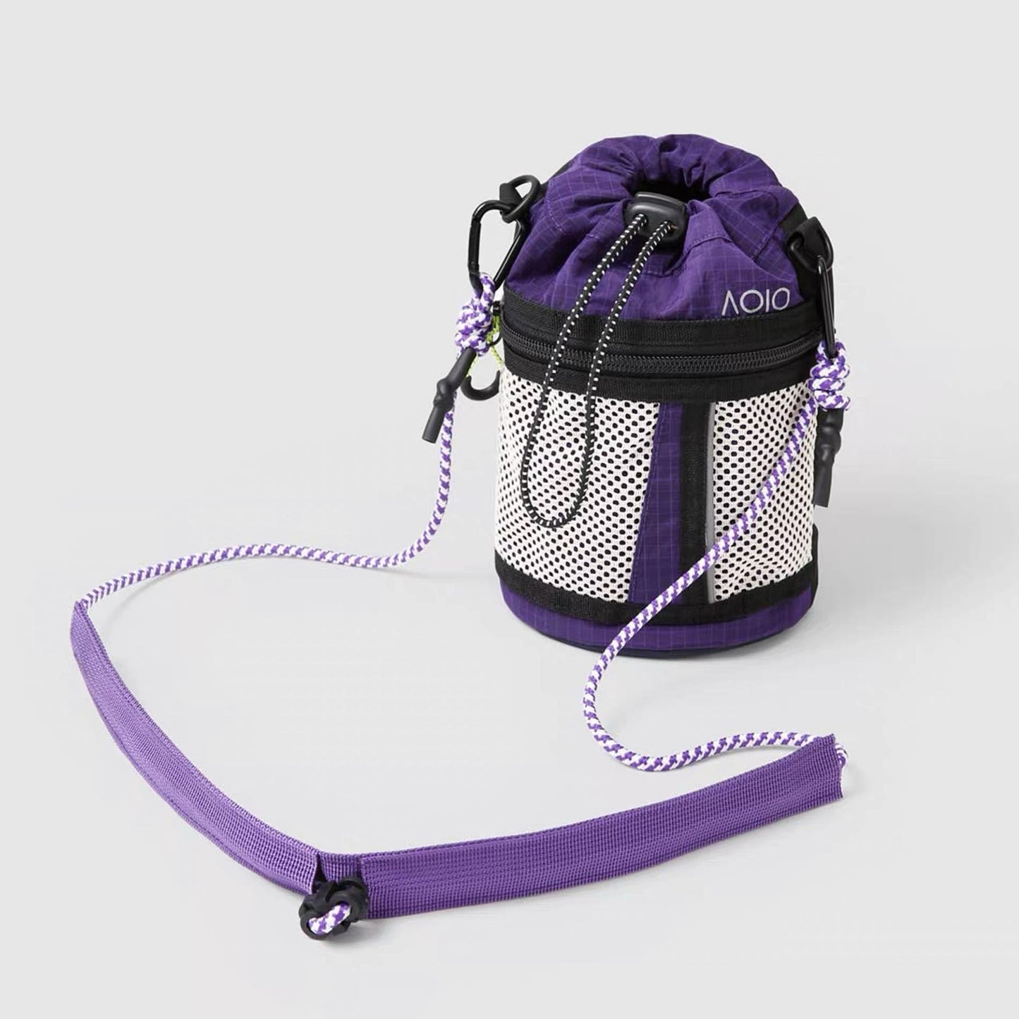 Front view of purple and black colorblock bucket bag, showcasing its precision stitching and durable tech fabric.