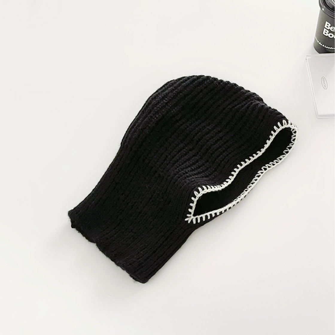 Front view of black balaclava hat with contrast edges, designed for a snug and stylish winter fit.