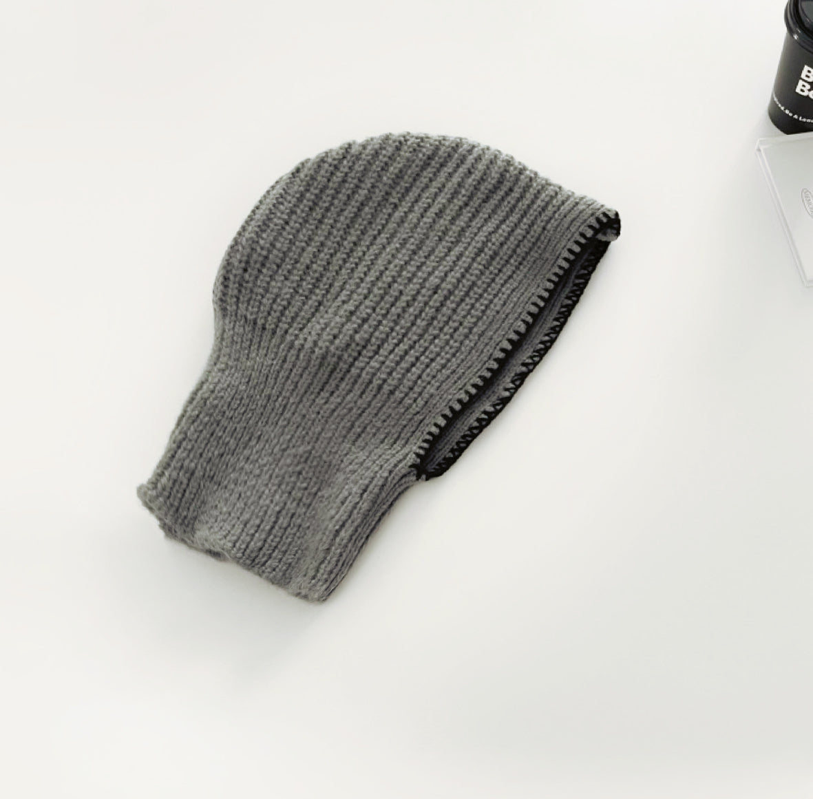 Front view of grey balaclava hat with contrast edges, featuring a soft and breathable knitted texture.