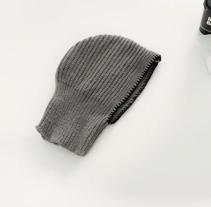 Front view of grey balaclava hat with contrast edges, featuring a soft and breathable knitted texture.