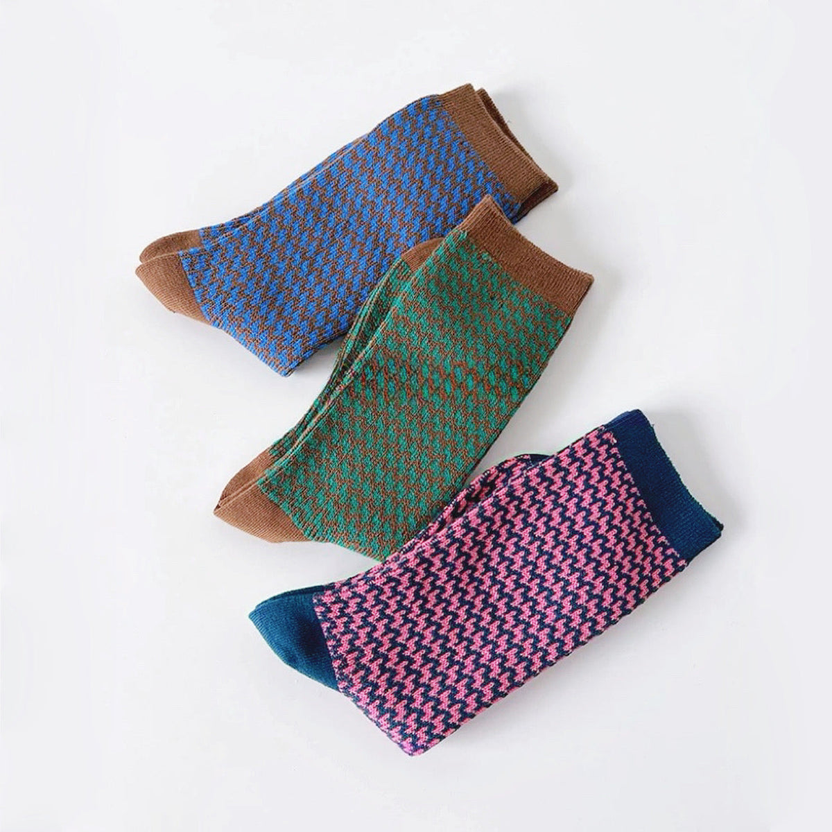 Angled view of 3 colors of Colored Houndstooth Socks, great for daily wear and lounging.