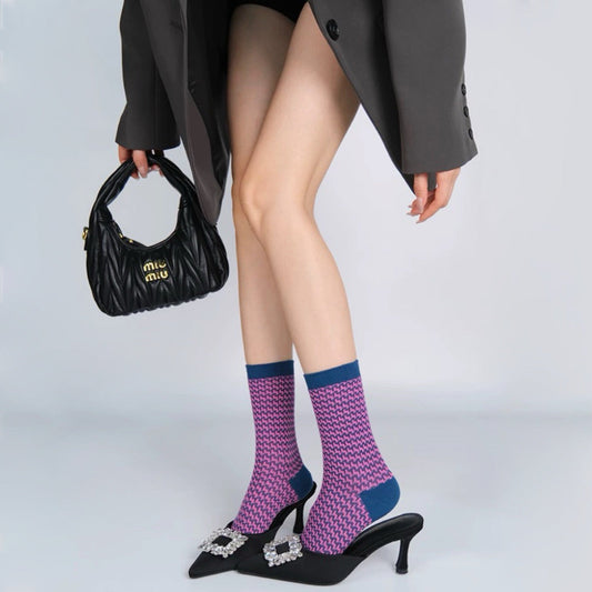 Model wearing a pair of pink houndstooth socks, ideal for everyday outfits and sneakers.